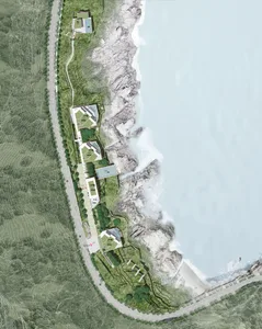 Aerial view of a residential development featuring multiple houses along a seaside cliffside.