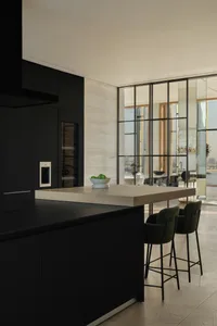 Modern kitchen featuring black cabinets and wood countertops.