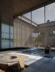 Modern interior design featuring glass walls, concrete flooring, and metal accents.