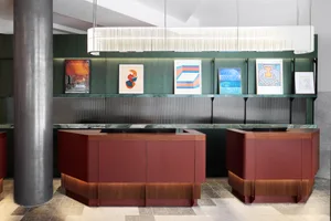 Modern reception desk featuring glass panels and wooden accents in a minimalist design.
