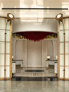 View of a modern hotel lobby featuring marble and concrete materials.