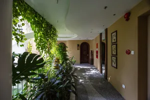 A hallway adorned with lush greenery and plant materials, combining natural elements with architectural design.