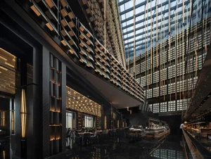 An industrial-style restaurant interior with modern design elements, featuring glass and metal materials, and contemporary li