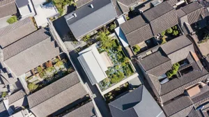 An aerial view of a cityscape featuring prominent use of terracotta architectural elements.