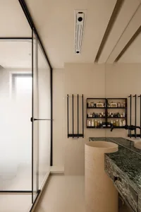 A modern minimalist bathroom with a glass shower door and sleek, minimalist elements.