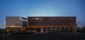 A modern office building with a wooden exterior during dusk.