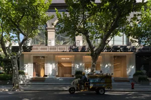 Modern storefront with large glass windows and stone facade
