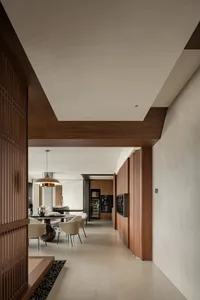 A modern dining and kitchen area featuring wooden elements and minimalist design.