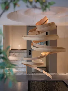 A modern living room featuring wooden circles suspended from the ceiling