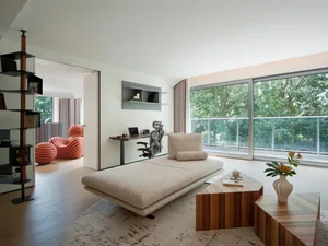 A modern living room with wooden structures, a comfortable seating area, and natural light.