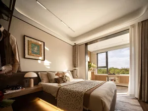 Minimalist bedroom featuring neutral tones and modern design elements.