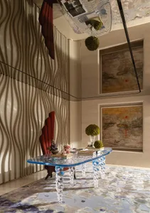 Modern living room featuring a glass table with clear legs.