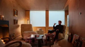 A modern residential living room with wooden walls and a comfortable seating area
