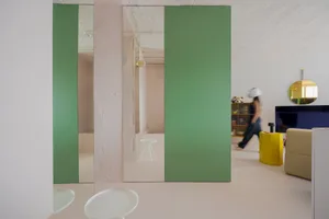 A modern interior with minimalist elements featuring a green panel wall.