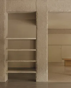 Concrete shelving unit in an industrial kitchen setting.