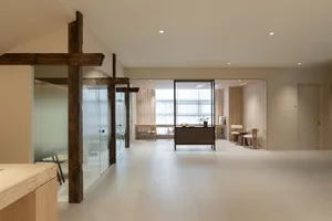 A minimalist modern office space featuring wood, glass, and concrete materials.