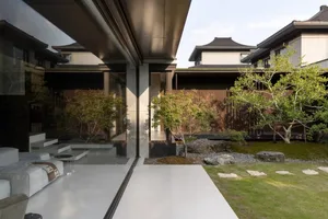 A modern residential exterior featuring a combination of glass and wood materials,with a minimalist design and an open floor 