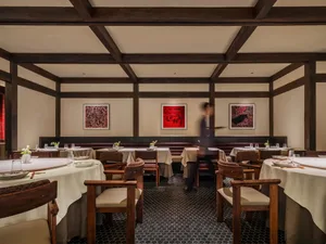 Restaurant interior with tables, chairs, and artistic wall decorations