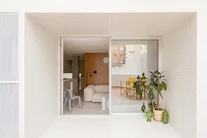 A minimalistic residential space featuring tile flooring and glass elements.
