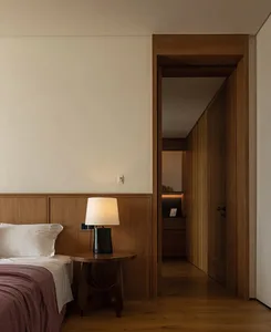 A bedroom featuring modern wood paneling and minimalist design