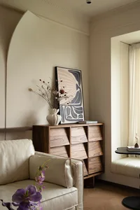 A modern living room featuring a wooden unit with plush seating and decorative elements.