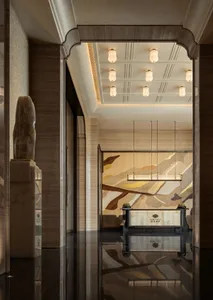 Modern lobby with marble flooring, draped curtains, and elegant furnishings.