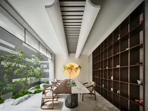 Modern library with bookshelves made of wood, stone, and metal.