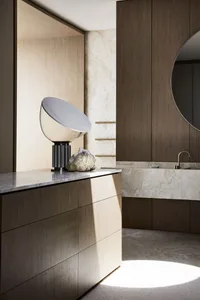 Modern bathroom interior featuring marble and wooden finishes