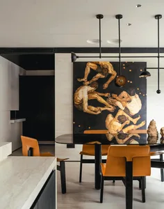 A modern dining room with a large, dark wood table surrounded by orange chairs, featuring a large abstract artwork depicting 