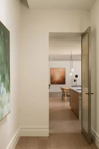 A contemporary kitchen featuring wooden cabinets and a stone countertop.