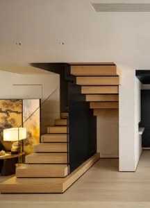 Modern interior design featuring a wooden staircase with floating steps and a sleek, minimalist aesthetic.
