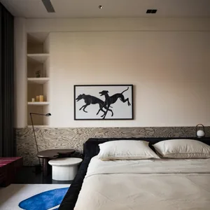 Modern bedroom with textured wall paneling and minimalist decor.
