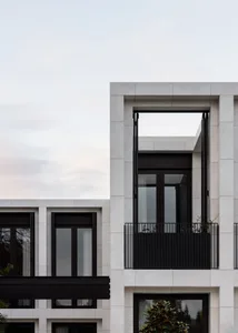 Modern residential mansion featuring minimalist architecture with white marble exterior.