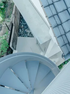 Modern metal stairs viewed from above, featuring smooth lines and a sleek design.