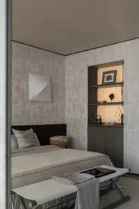 A minimalist bedroom featuring a bed with a textured headboard and a bench with a metal base, against a wall with a geometric