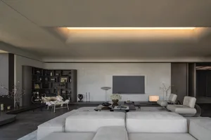 A modern living room with neutral-toned furniture and minimalist design elements.