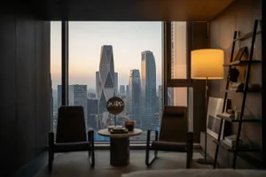 Modern living room featuring glass, concrete, and metal materials.