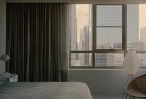 Modern bedroom with textured grey curtains on a large window