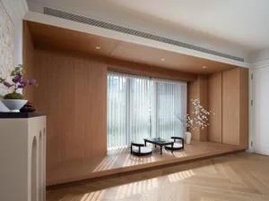 Modern minimalist living room featuring a wood floor and furniture.