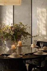 A modern dining room featuring a floral centerpiece with marble elements.