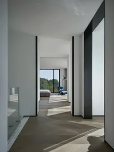 A minimalist bedroom with a wooden floor and a bed.