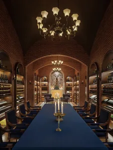 A spacious industrial-style wine cellar with brick walls, wooden furniture, and an array of wine bottles displayed on shelves