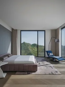 A modern minimalist bedroom featuring a sleek, upholstered bed with a glass headboard, a smart touch bedside table, and a con