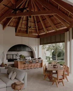 Outdoor seating area with wooden furniture and pergola structure