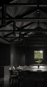 A modern minimalist restaurant interior with dark tones and wooden materials.