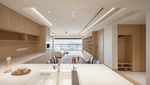 A minimalist residential kitchen featuring wooden cabinetry and countertops.