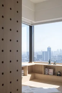 Modern room featuring wood shelves and a city view.