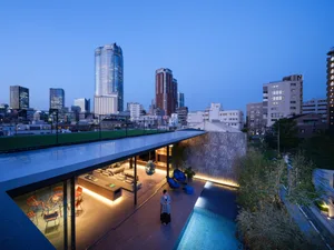 A modern rooftop residence featuring contemporary design elements such as glass walls and wooden flooring.