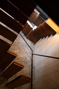 Modern architecture with wooden stairs on a concrete floor.
