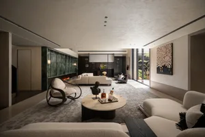 A modern living room with neutral tones and marble accents, featuring a cozy fireplace and comfortable seating.